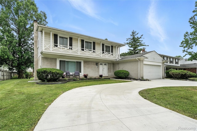 22679 Bell Brook St, Southfield, MI 48034 - traditional home with a balcony, a chimney, driveway, brick siding, and a garage