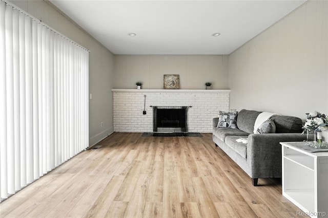 22679 Bell Brook St, Southfield, MI 48034 - living room with a fireplace and light wood-style floors
