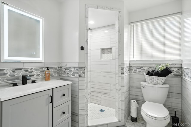 22679 Bell Brook St, Southfield, MI 48034 - full bathroom with tile walls, a tile shower, vanity, and wainscoting