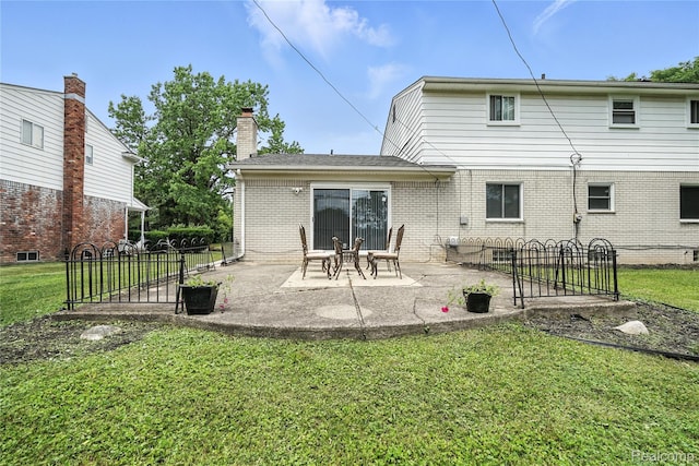 22679 Bell Brook St, Southfield, MI 48034 - rear view of property featuring brick siding, a patio area, and a chimney