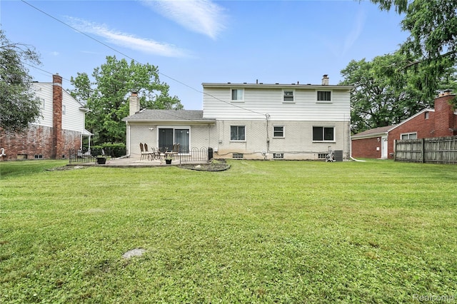 22679 Bell Brook St, Southfield, MI 48034 - rear view of property with a patio, a chimney, and brick siding