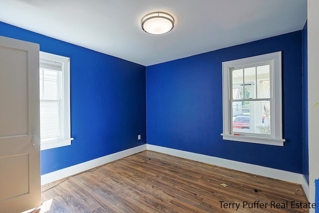 594 Oak Ave, Muskegon, MI 49442 - spare room featuring healthy amount of natural light and wood finished floors