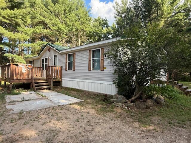 1422 E Monroe St, White Cloud, MI 49349 - rear view of house with a wooden deck