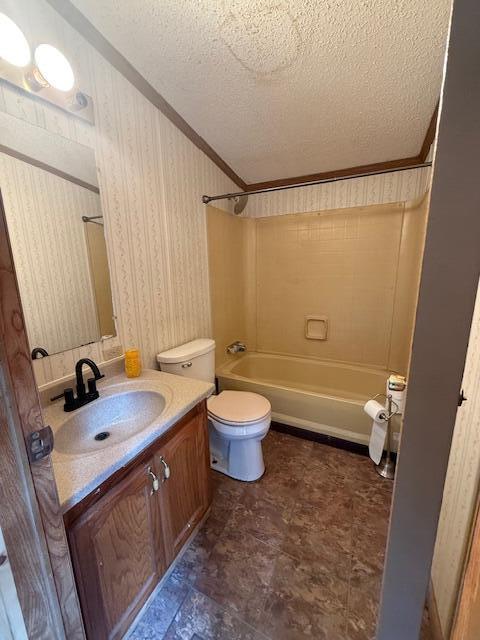 1422 E Monroe St, White Cloud, MI 49349 - bathroom featuring vanity, bathing tub / shower combination, a textured ceiling, and ornamental molding