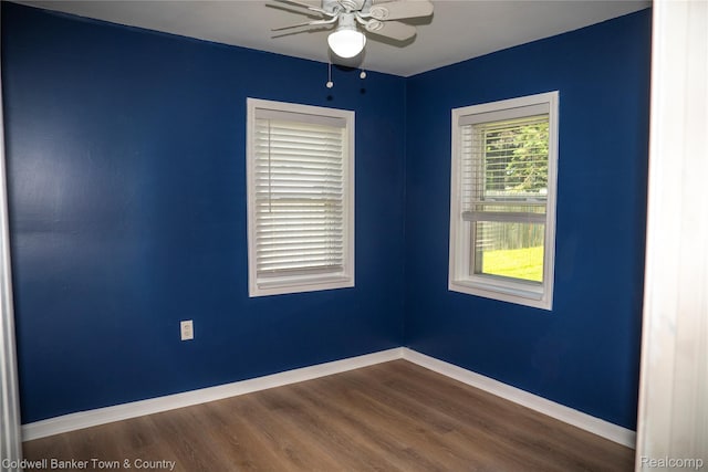 528 W Clinton St, Howell, MI 48843 - spare room with ceiling fan and dark wood-style floors
