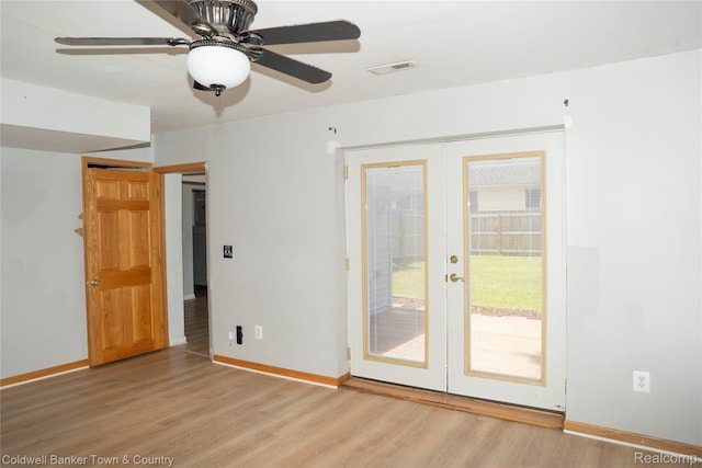 528 W Clinton St, Howell, MI 48843 - empty room featuring french doors, light wood-style flooring, and a ceiling fan