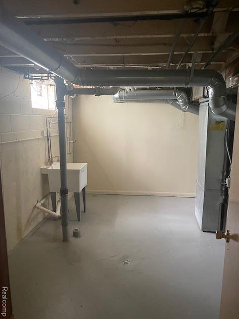 8645 Minock St, Detroit, MI 48228 - basement with heating unit and a sink