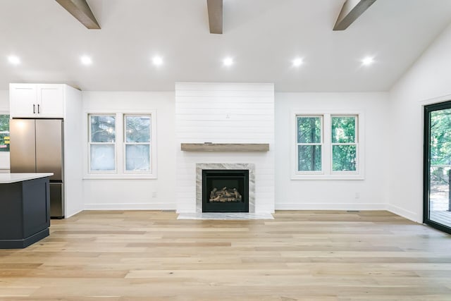 4046 Hillside Trl, New Buffalo, MI 49117 - unfurnished living room featuring ceiling fan, light wood finished floors, recessed lighting, and a premium fireplace