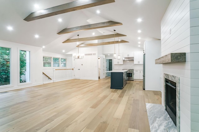 4046 Hillside Trl, New Buffalo, MI 49117 - unfurnished living room featuring beam ceiling, light wood-type flooring, recessed lighting, a premium fireplace, and high vaulted ceiling