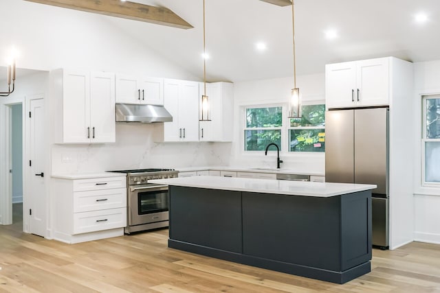 4046 Hillside Trl, New Buffalo, MI 49117 - kitchen featuring under cabinet range hood, stainless steel appliances, light countertops, white cabinets, and beamed ceiling