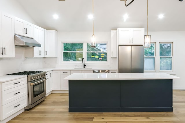 4046 Hillside Trl, New Buffalo, MI 49117 - kitchen featuring appliances with stainless steel finishes, under cabinet range hood, a kitchen island, light countertops, and recessed lighting