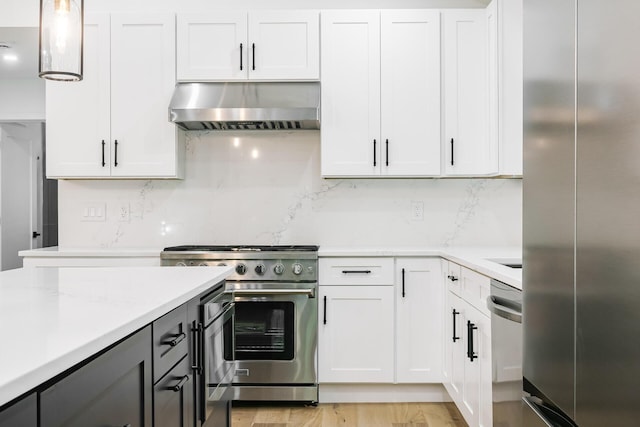 4046 Hillside Trl, New Buffalo, MI 49117 - kitchen featuring wall chimney range hood, premium appliances, light countertops, and tasteful backsplash