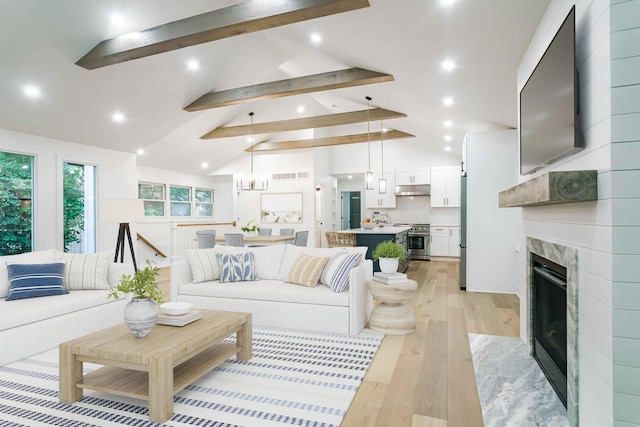 4046 Hillside Trl, New Buffalo, MI 49117 - living area featuring recessed lighting, light wood finished floors, beam ceiling, a high end fireplace, and a chandelier
