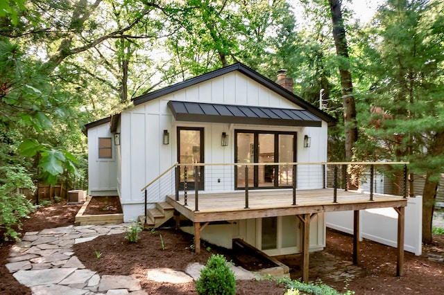 4046 Hillside Trl, New Buffalo, MI 49117 - view of front of property with a deck, a chimney, a standing seam roof, a metal roof, and board and batten siding