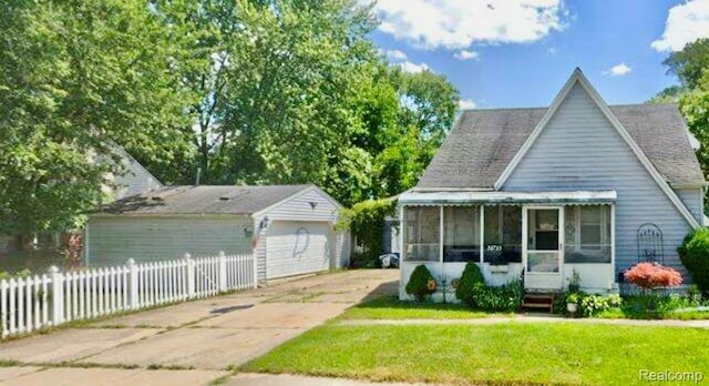 26735 Annapolis St, Dearborn Heights, MI 48125 - view of front of property with a sunroom and an outbuilding