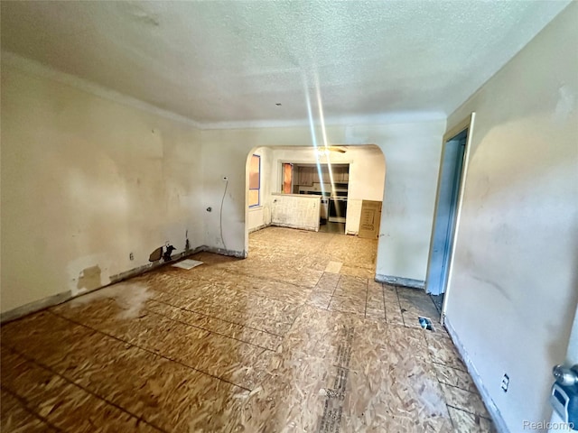 26735 Annapolis St, Dearborn Heights, MI 48125 - unfurnished living room with arched walkways, a textured ceiling, and crown molding
