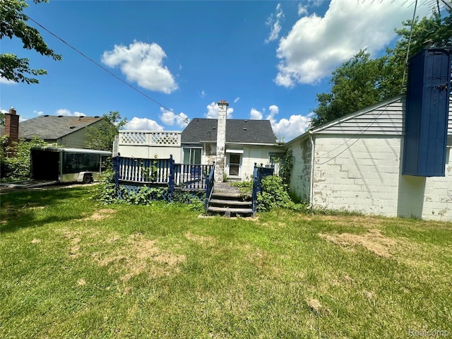 26735 Annapolis St, Dearborn Heights, MI 48125 - rear view of property featuring a deck and a yard