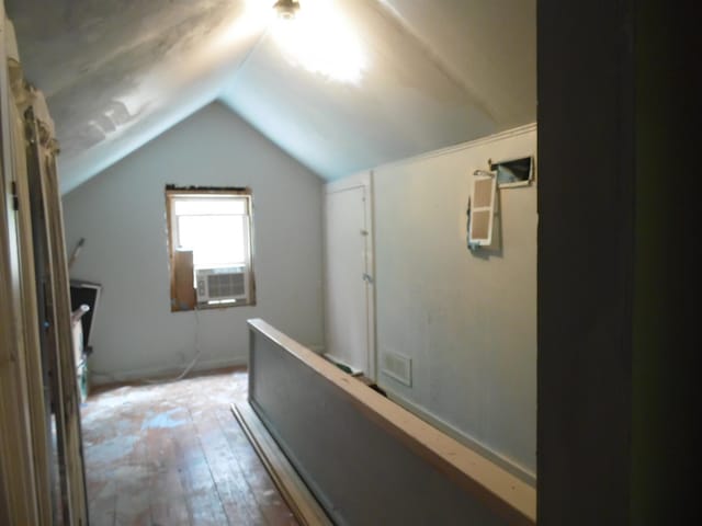5294 Pinecrest, Prescott, MI 48756 - hallway with lofted ceiling and hardwood / wood-style flooring