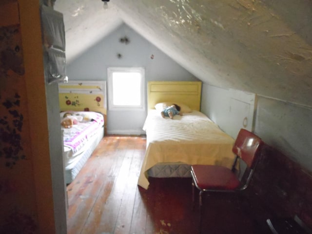 5294 Pinecrest, Prescott, MI 48756 - bedroom featuring hardwood / wood-style floors and vaulted ceiling