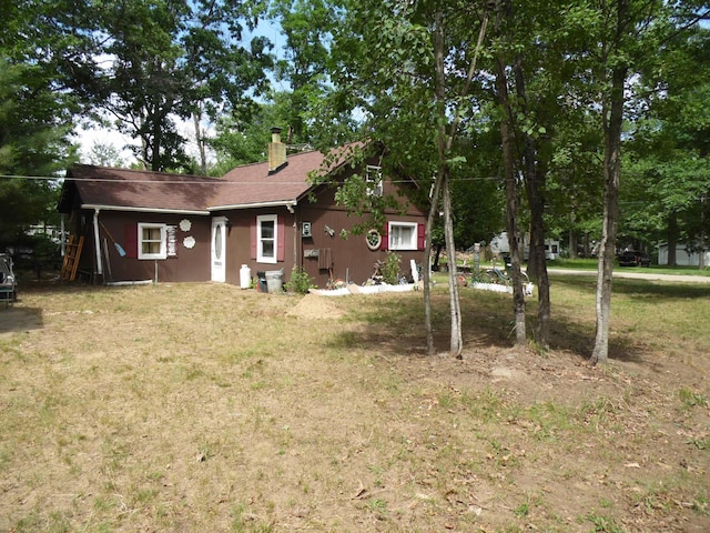 5294 Pinecrest, Prescott, MI 48756 - rear view of house with a chimney and a lawn