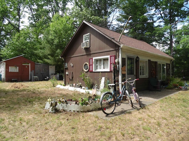 5294 Pinecrest, Prescott, MI 48756 - view of front facade with cooling unit and a shingled roof