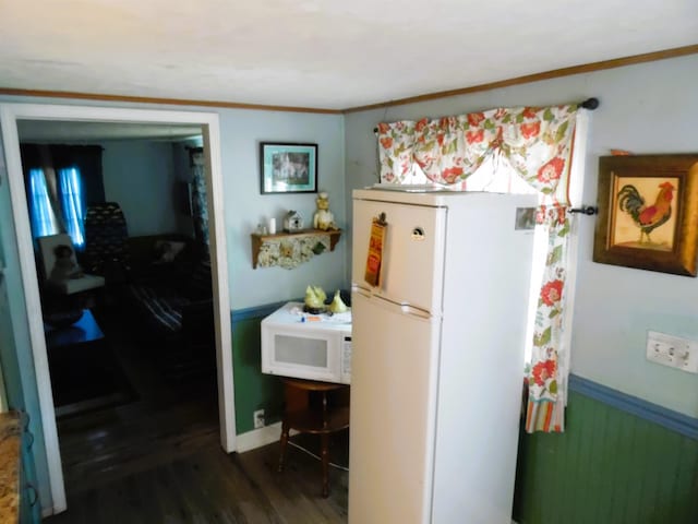 5294 Pinecrest, Prescott, MI 48756 - kitchen featuring white appliances, dark wood-style flooring, a wainscoted wall, and ornamental molding