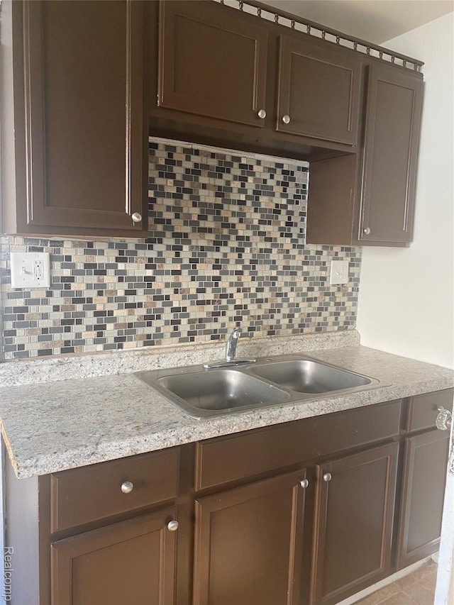 25 Marie St, Detroit, MI 48229 - kitchen with tasteful backsplash and dark brown cabinetry