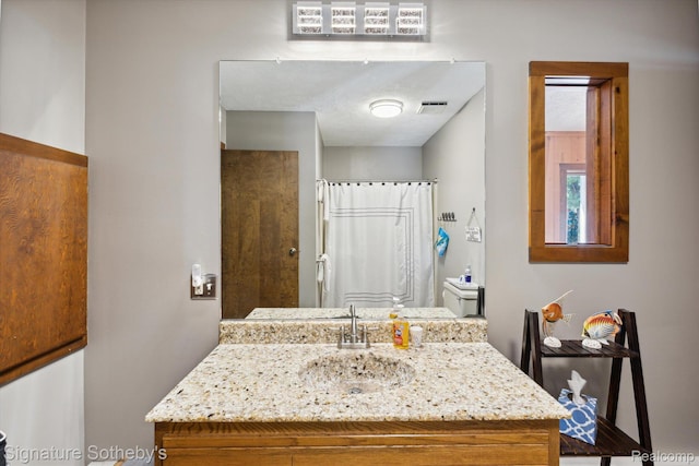 8641 Brettonwood Shores Rd, Rapid City, MI 49676 - bathroom featuring vanity and a shower with shower curtain