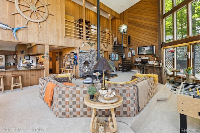 8641 Brettonwood Shores Rd, Rapid City, MI 49676 - carpeted living room with a high ceiling and wood walls