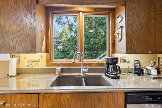 8641 Brettonwood Shores Rd, Rapid City, MI 49676 - kitchen with dishwashing machine and brown cabinets