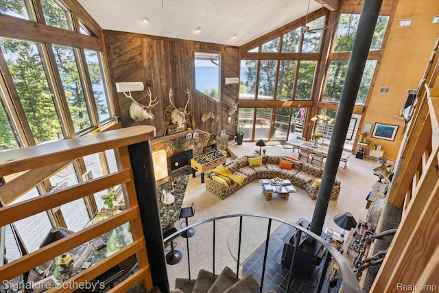 8641 Brettonwood Shores Rd, Rapid City, MI 49676 - living area with carpet floors and high vaulted ceiling