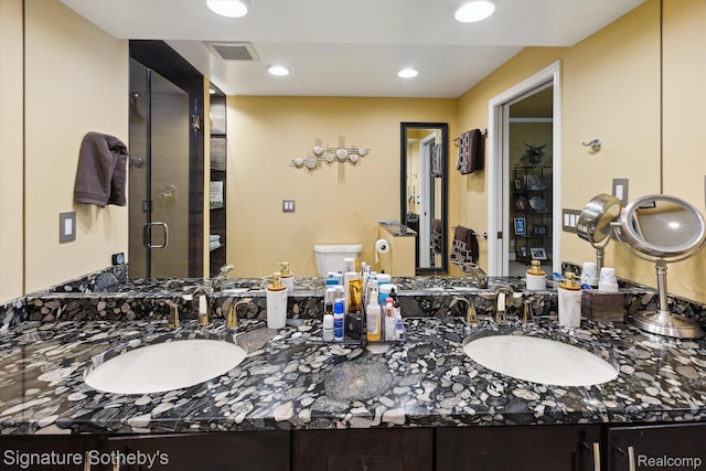 8641 Brettonwood Shores Rd, Rapid City, MI 49676 - full bathroom with double vanity, a shower stall, and recessed lighting