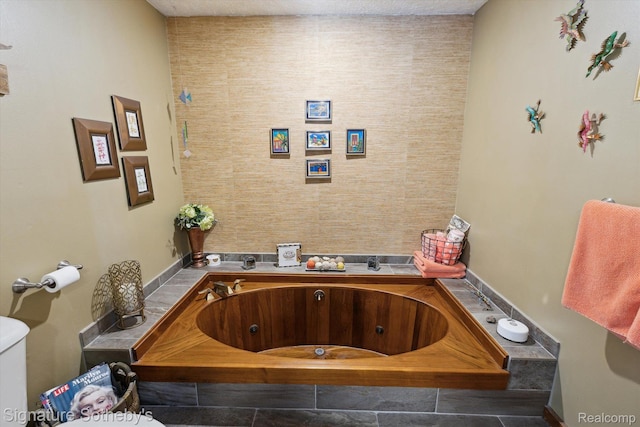 8641 Brettonwood Shores Rd, Rapid City, MI 49676 - bathroom with a jetted tub and toilet