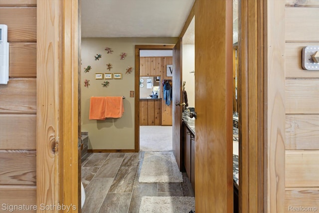 8641 Brettonwood Shores Rd, Rapid City, MI 49676 - hallway featuring stone finish floors and baseboards