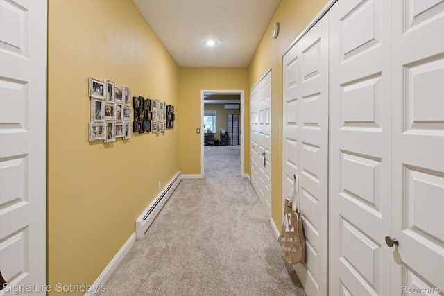 8641 Brettonwood Shores Rd, Rapid City, MI 49676 - corridor featuring a baseboard radiator and light carpet