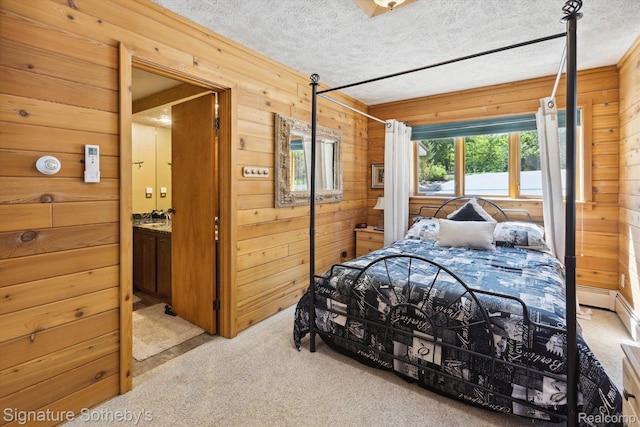 8641 Brettonwood Shores Rd, Rapid City, MI 49676 - bedroom with wood walls, light carpet, a textured ceiling, and ensuite bath