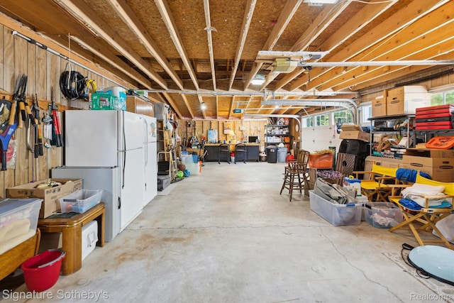 8641 Brettonwood Shores Rd, Rapid City, MI 49676 - garage with freestanding refrigerator