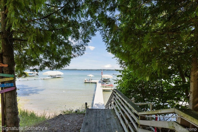 8641 Brettonwood Shores Rd, Rapid City, MI 49676 - water view featuring a boat dock