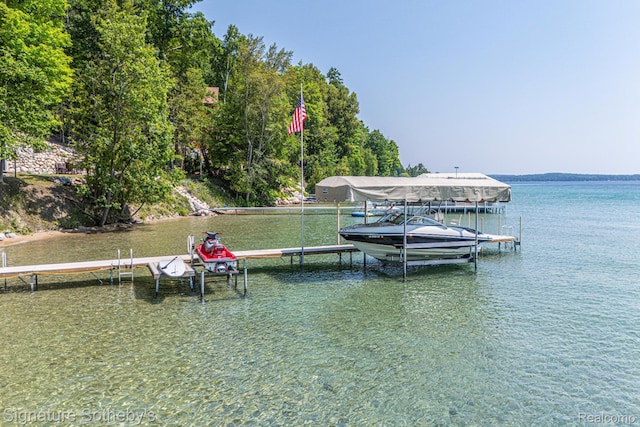 8641 Brettonwood Shores Rd, Rapid City, MI 49676 - dock area featuring boat lift and a water view