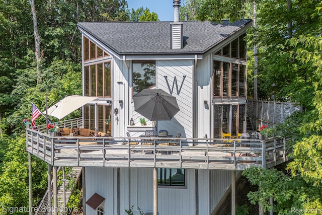 8641 Brettonwood Shores Rd, Rapid City, MI 49676 - rear view of property featuring a deck and a sunroom