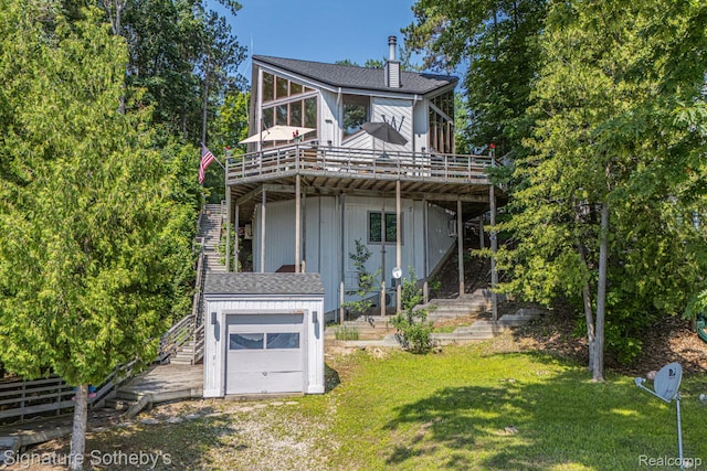8641 Brettonwood Shores Rd, Rapid City, MI 49676 - view of front of property featuring stairway, a deck, a garage, and a front yard