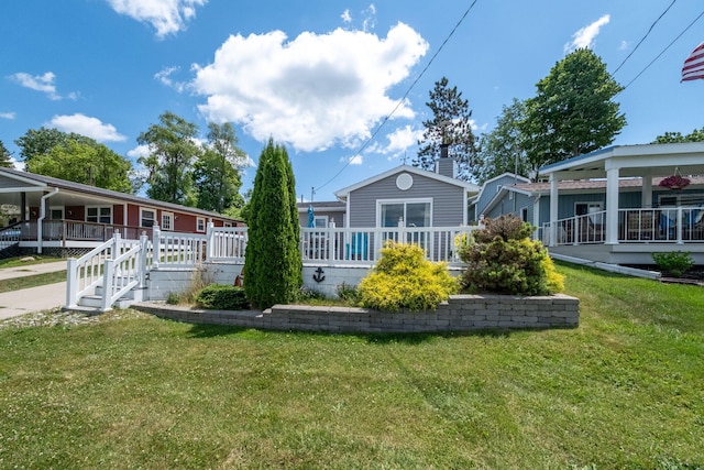 19336 E Chippewa Dr, Chippewa Lake, MI 49320 - rear view of house featuring a chimney, a lawn, and a deck