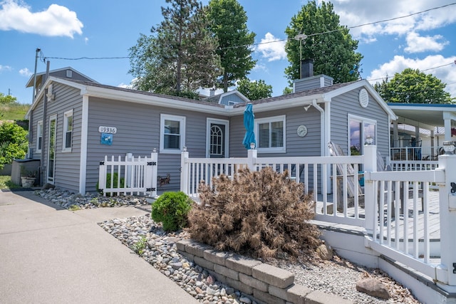 19336 E Chippewa Dr, Chippewa Lake, MI 49320 - view of front of property featuring a chimney and covered porch
