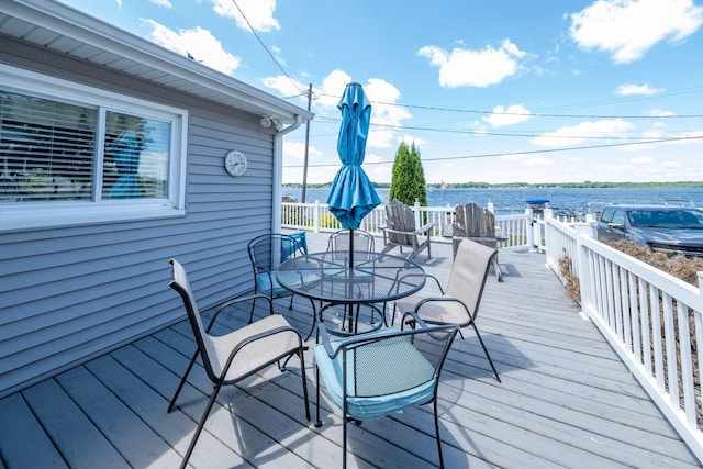 19336 E Chippewa Dr, Chippewa Lake, MI 49320 - wooden terrace featuring outdoor dining area and a water view