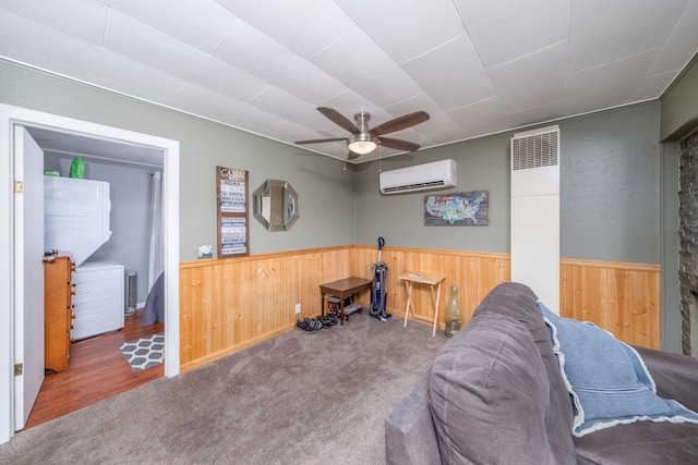 19336 E Chippewa Dr, Chippewa Lake, MI 49320 - sitting room featuring a wall mounted air conditioner, wainscoting, wood walls, ceiling fan, and wood finished floors