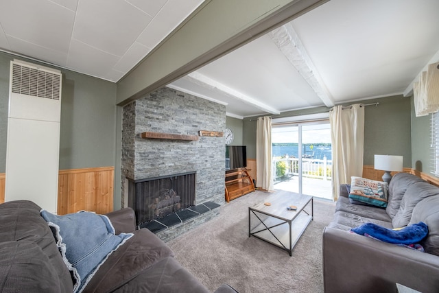 19336 E Chippewa Dr, Chippewa Lake, MI 49320 - carpeted living room with a stone fireplace, beamed ceiling, a wainscoted wall, and wood walls