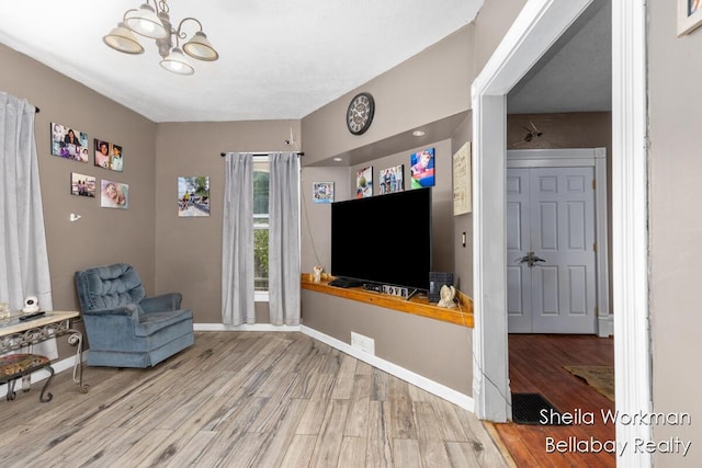 803 S Hanover St, Hastings, MI 49058 - living area featuring wood finished floors and a chandelier
