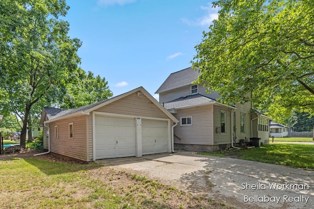 803 S Hanover St, Hastings, MI 49058 - view of property exterior with a detached garage, an outdoor structure, and a yard