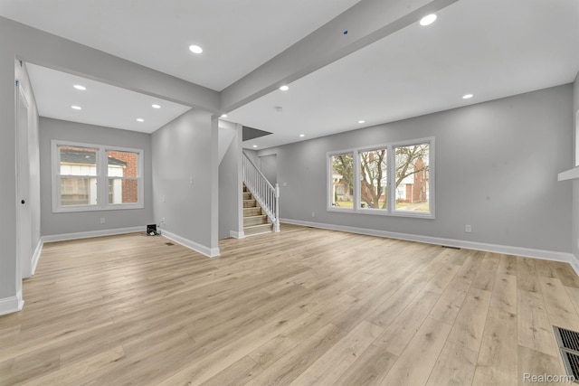 5291 Devonshire Rd, Detroit, MI 48224 - unfurnished living room featuring stairs, light wood-style flooring, and recessed lighting