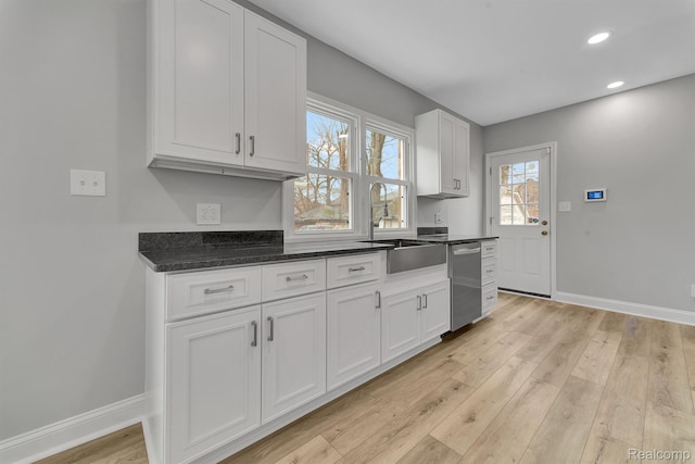 5291 Devonshire Rd, Detroit, MI 48224 - kitchen with dishwasher, light wood-style flooring, white cabinets, recessed lighting, and dark stone counters